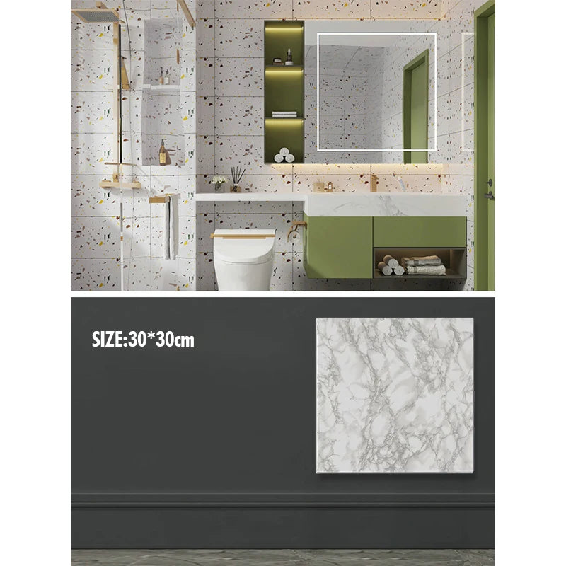 A modern bathroom interior featuring marble wall decals, green cabinetry, and a white toilet.