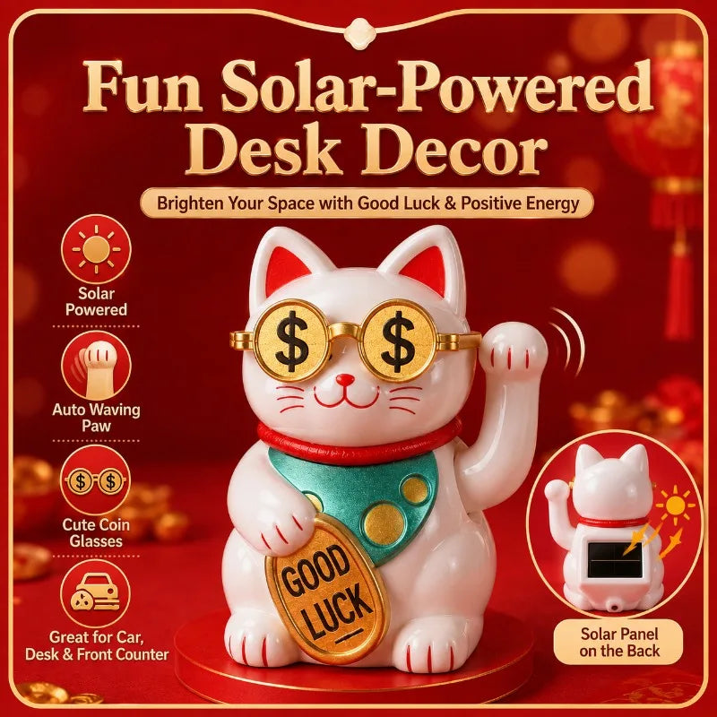 A white cat ornament wearing gold glasses and a green collar sits on a red base, decorated with coins, next to a solar panel.