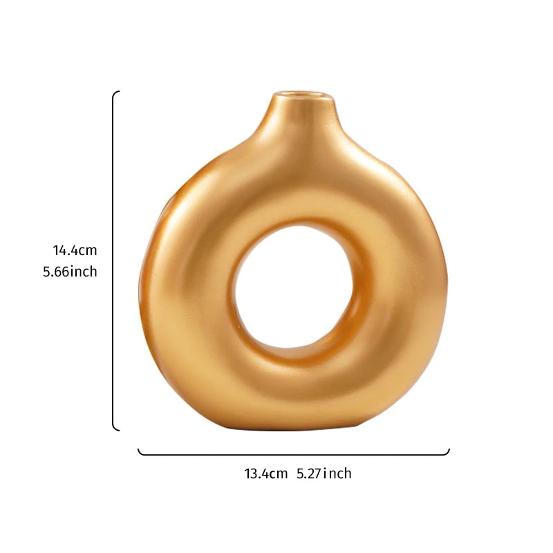 A smooth, golden, ring-shaped resin vase with a rounded top.