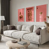 A modern living room features a light sofa and wooden table with framed retro letter art canvases on the wall.