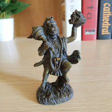 A bronze-colored resin statue of Hanuman, the Hindu monkey god, standing on a base.