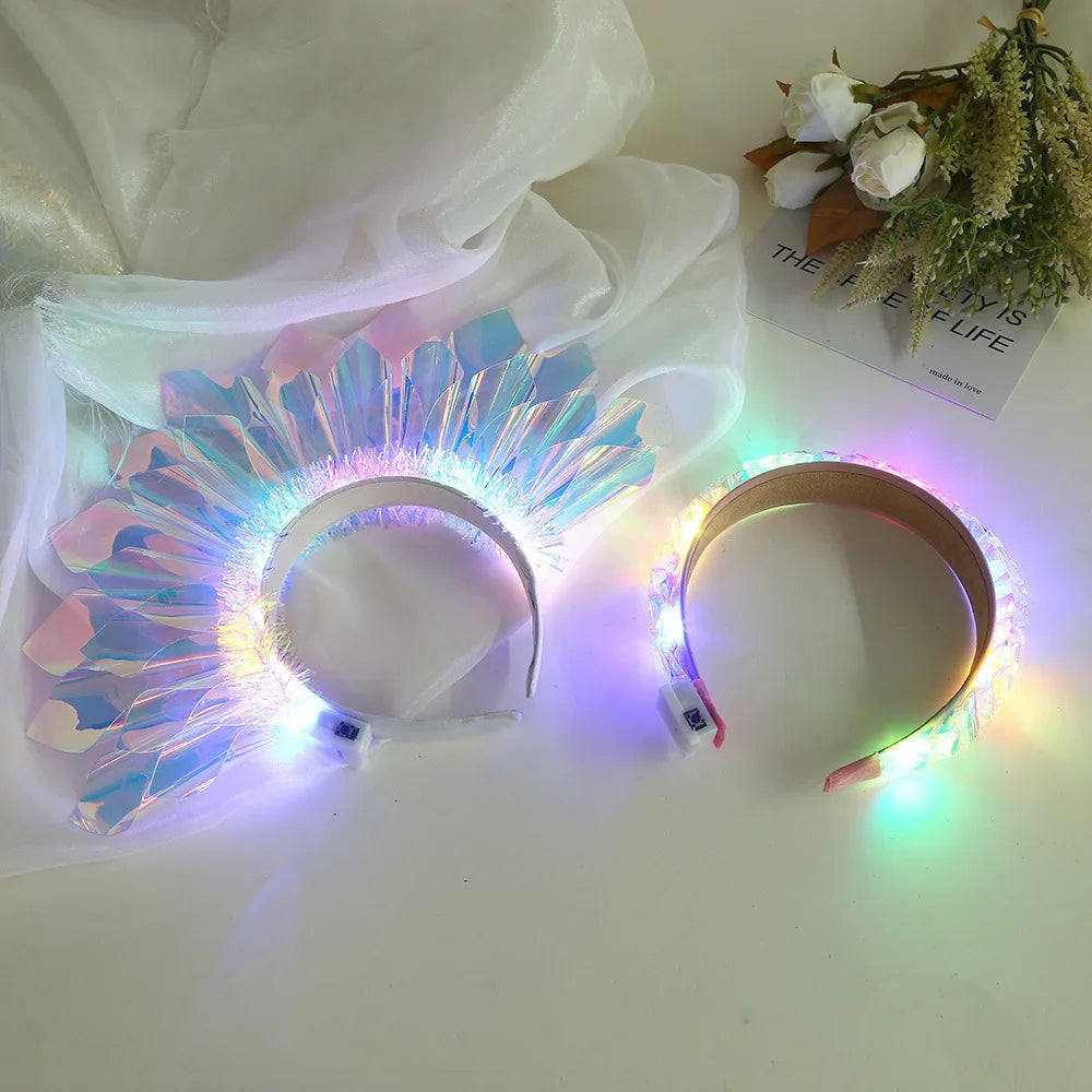 A glowing LED headband with a floral design is displayed on a white surface.