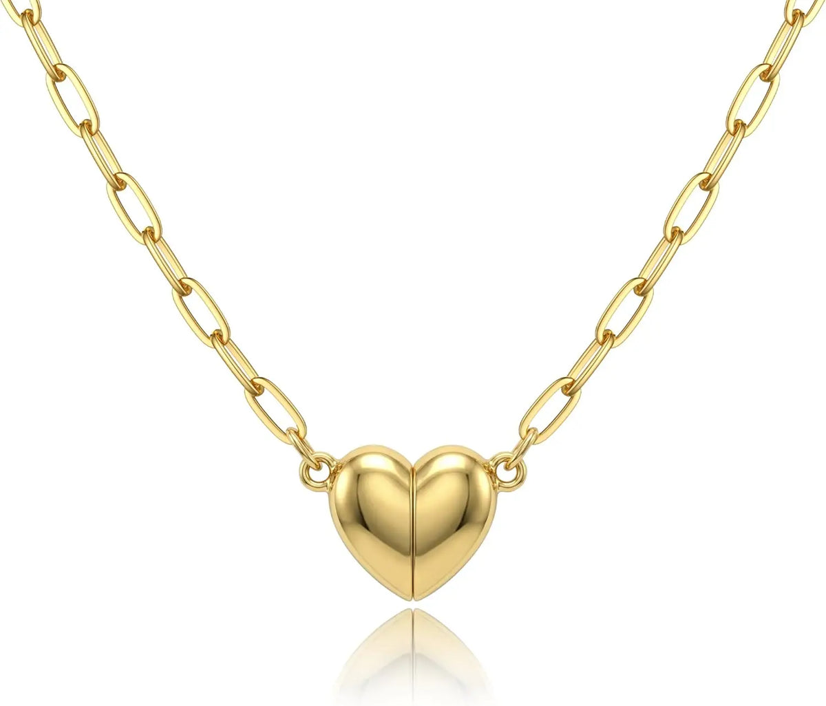 A delicate gold-colored chain necklace featuring a heart pendant with a magnetic clasp.
