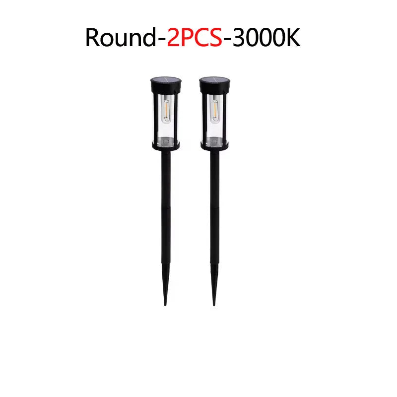 Two round solar pathway lights with LED bulbs and black fixtures.