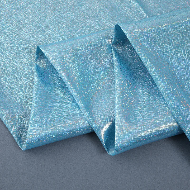 Blue iridescent sequin fabric draped in folds for a photography backdrop