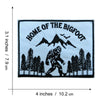 Black embroidered patch featuring the text Home of the Bigfoot and a silhouette of a Bigfoot figure among evergreen trees