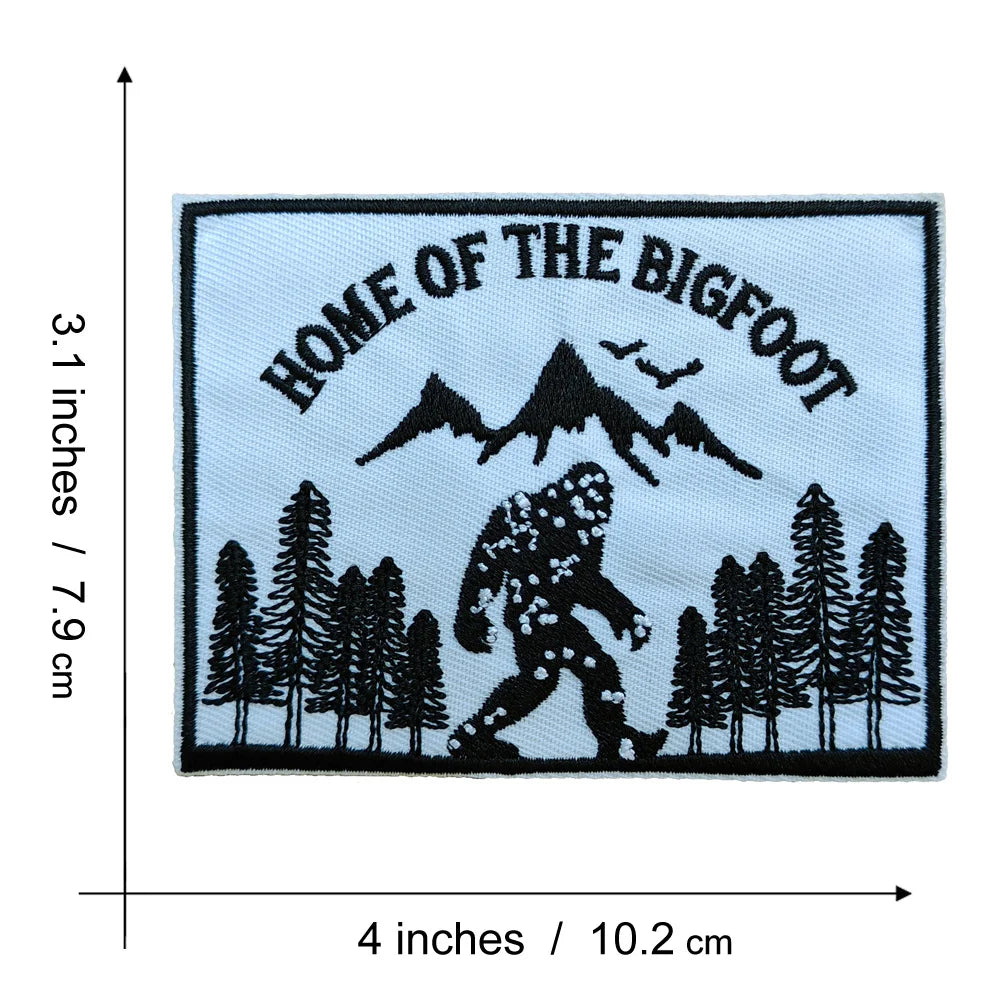 Black embroidered patch featuring the text Home of the Bigfoot and a silhouette of a Bigfoot figure among evergreen trees