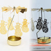 Gold rotating candle holder with heat-powered spinning carousel featuring cutout reindeer designs.