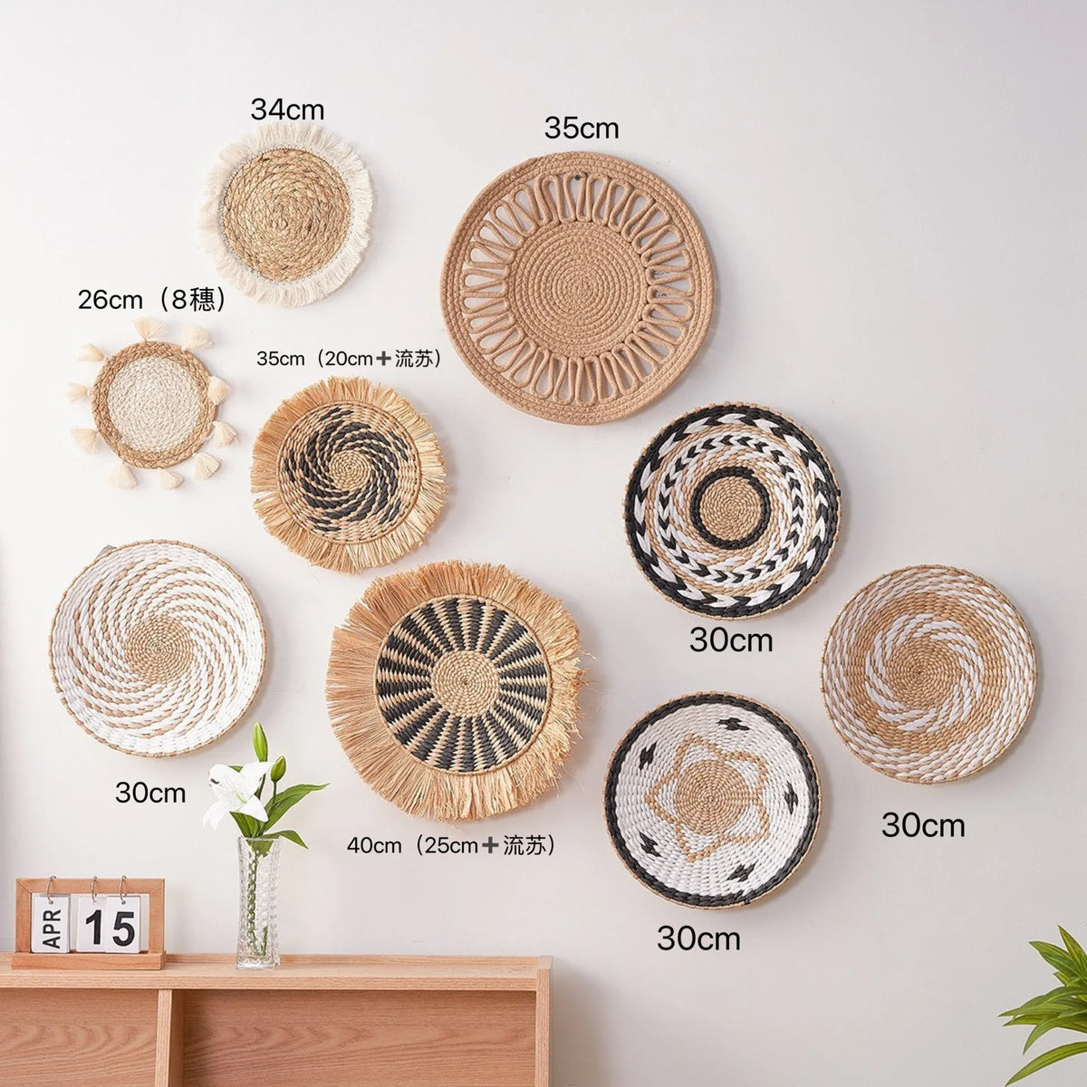 A collection of round boho straw wall hangings with varying diameters and woven tassels displayed on a white wall.