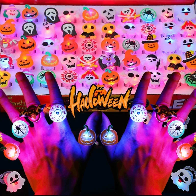 A close-up of a hand holding a tray of colorful Halloween glow rings and light-up party favors.
