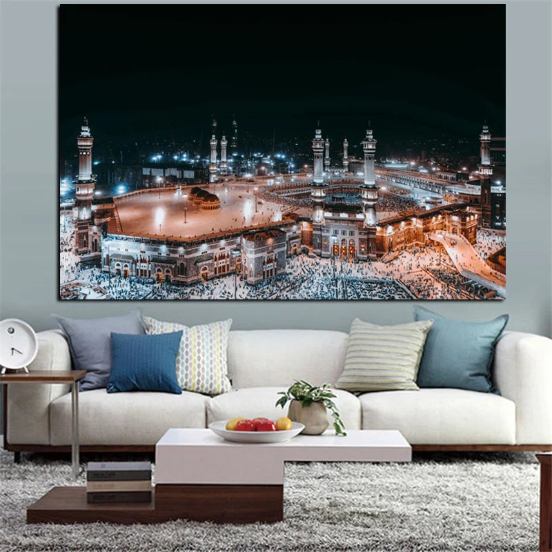 A canvas wall art print depicting the Kaaba and Al Masjid An Nabawi at night, displayed in a living room setting.
