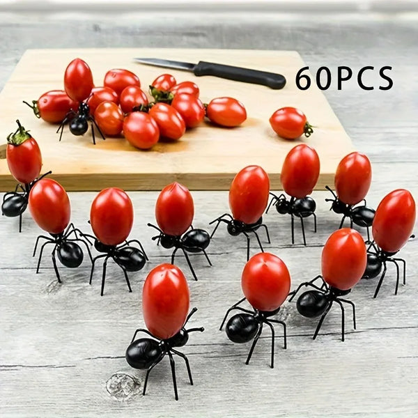 60 pieces of reusable ant-shaped plastic toothpicks and fruit forks for party snacks arranged on a wooden board.