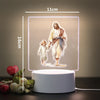 A 3D LED night light featuring a painting of Jesus and a child, illuminated with soft light.