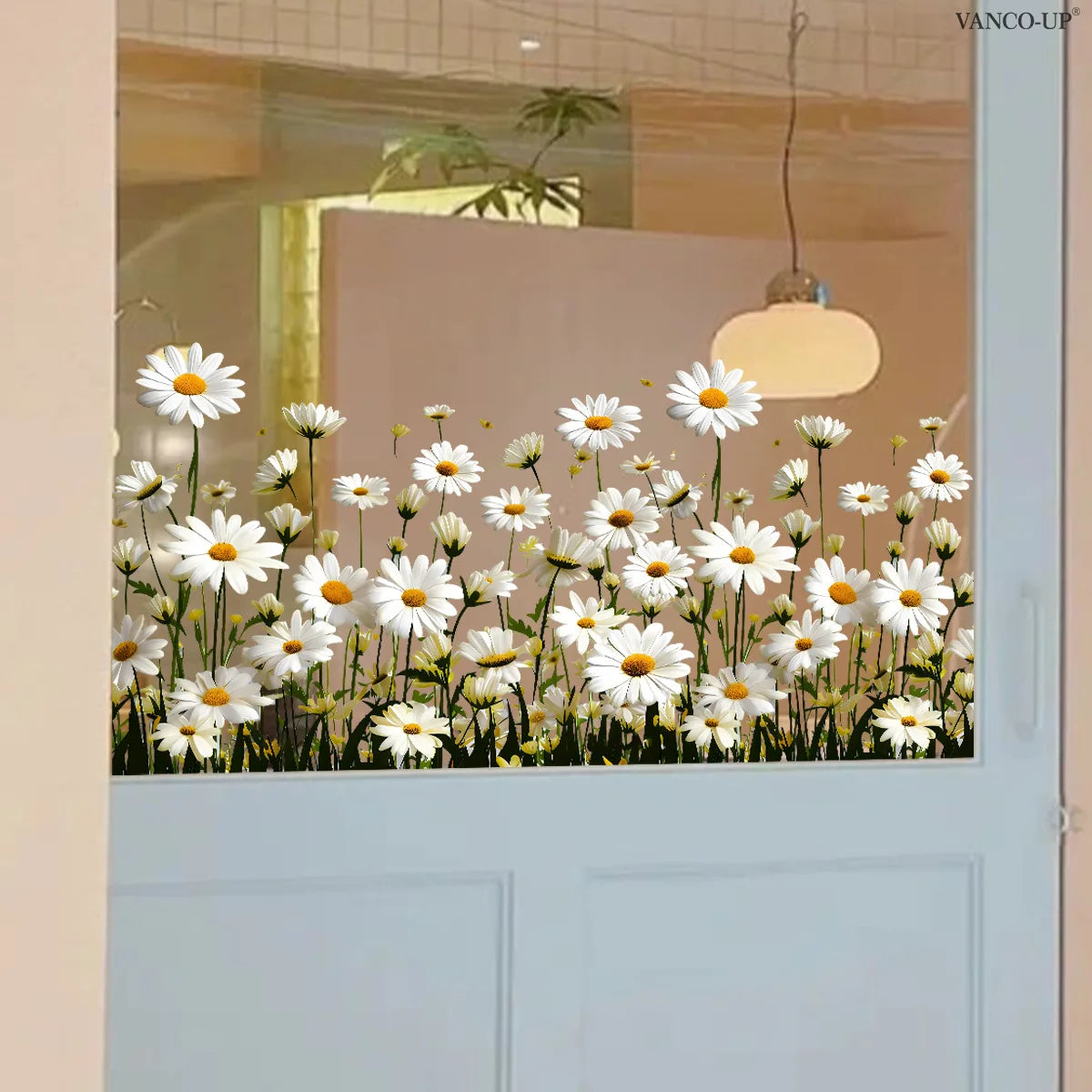 White daisy flower static cling window decals decorating a glass door with a warm light fixture.