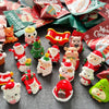 A collection of festive Santa Claus and snowman figurines in various colors and packaging for Christmas decor.