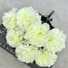 A bouquet of white silk artificial chrysanthemum flowers displayed on a dark surface.