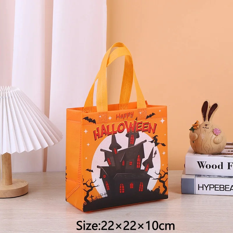 An orange Halloween themed non-woven gift tote bag with a yellow handle and festive print displayed on a wooden surface.