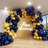 A large balloon arch decorated with gold and navy blue balloons forming an archway backdrop.