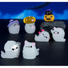 A set of seven cute luminous ghost resin ornaments in various colors and shapes displayed on a dark surface.