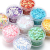 A collection of colorful sea shell PVC sequins in various shades and sizes for nail art and craft decoration.