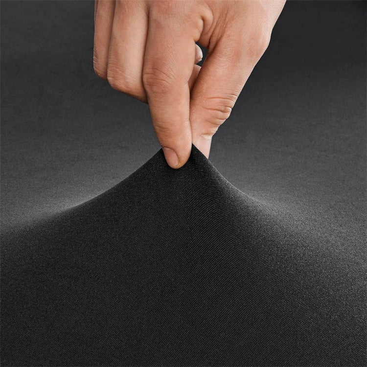A hand is touching the fabric of a black stretch spandex cocktail tablecloth skirt.