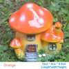 Orange resin mushroom house garden statue with a terracotta-colored cap and yellow body