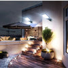 Outdoor security lighting illuminating a wooden deck and surrounding wall with bright LED lights