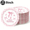 A stack of pink gingham paper plates decorated with pink bows for a birthday party.