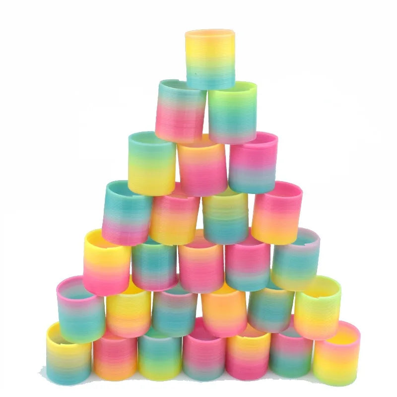 A pyramid of 24 colorful, translucent silicone spring toys in a rainbow gradient.