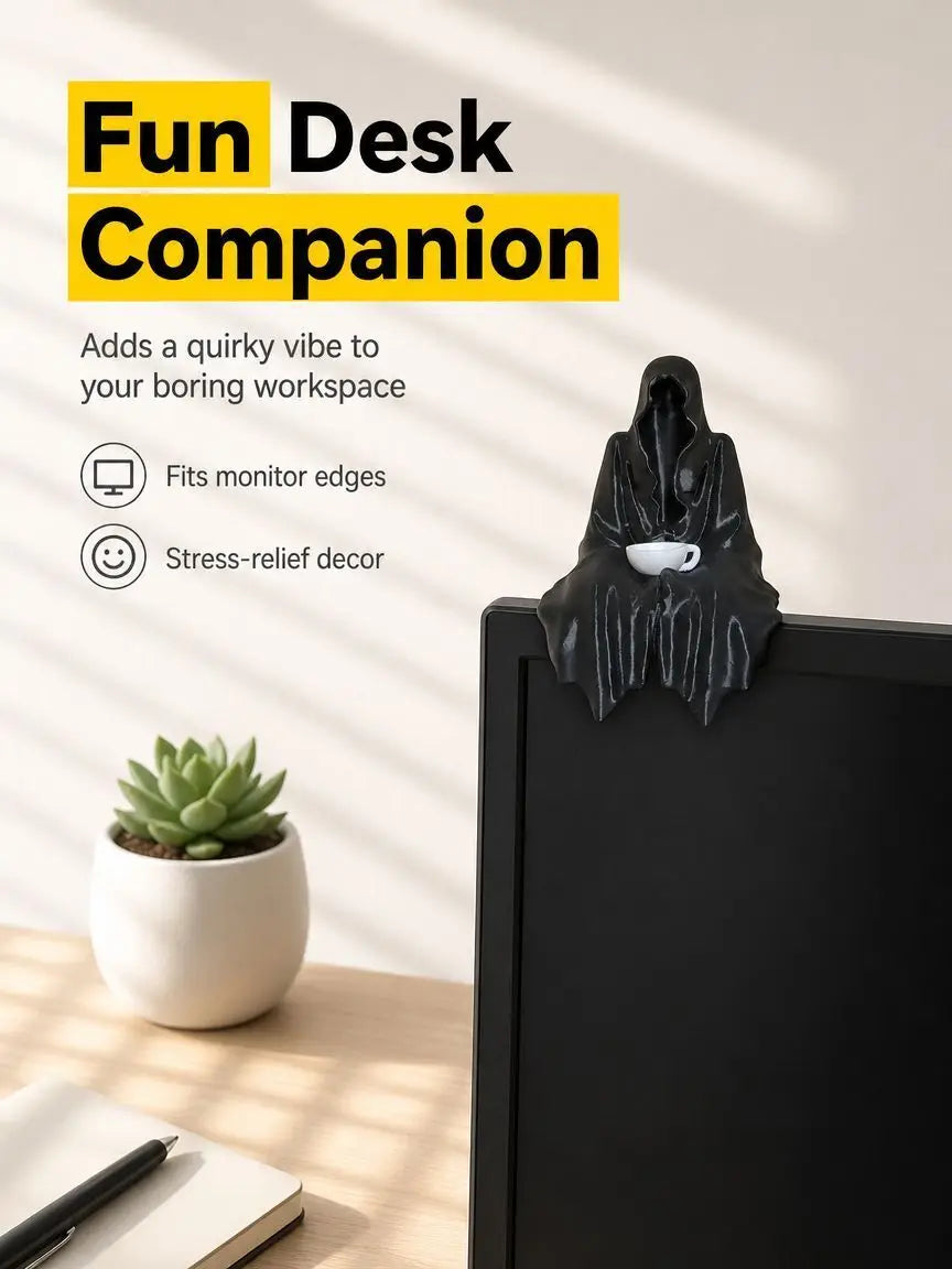 A black resin statue of a Halloween ghost with a tea cup sits on a desk next to a succulent plant.