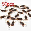 Fifty plastic cockroach gag toys scattered on a white background.