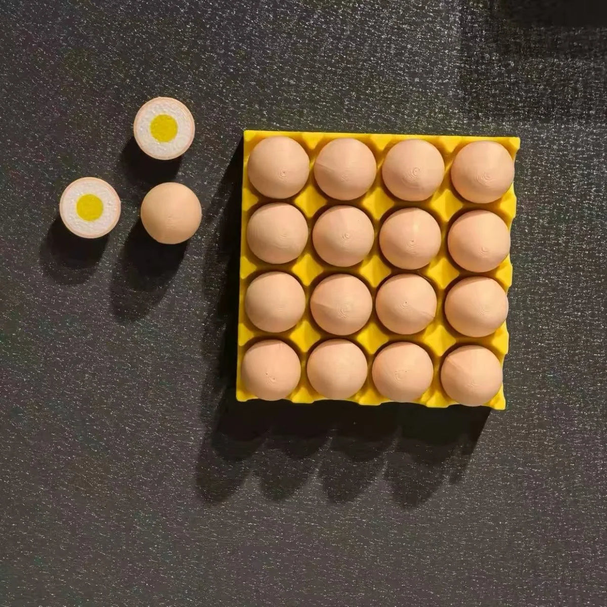 A yellow magnetic egg tray filled with light pink eggs and a few sliced eggs is displayed on a dark surface.