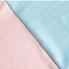 A close-up of a stretchable arch backdrop cover in soft pink and light blue fabric.