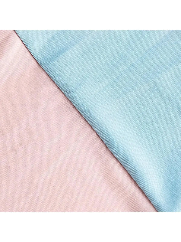 A close-up of a stretchable arch backdrop cover in soft pink and light blue fabric.