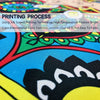 Close-up of a vibrant blue and green fabric featuring a decorative boxing flag design.