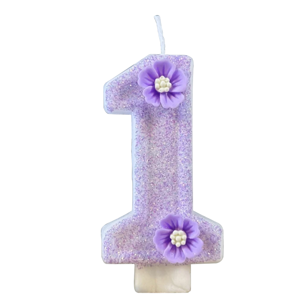A purple sparkling number candle shaped like the number one with a small flower decoration.