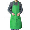 A person wearing a bright green waterproof kitchen apron over a gray sweater.