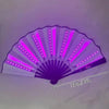A purple glow folding LED fan with radiating light strips, shown from above.