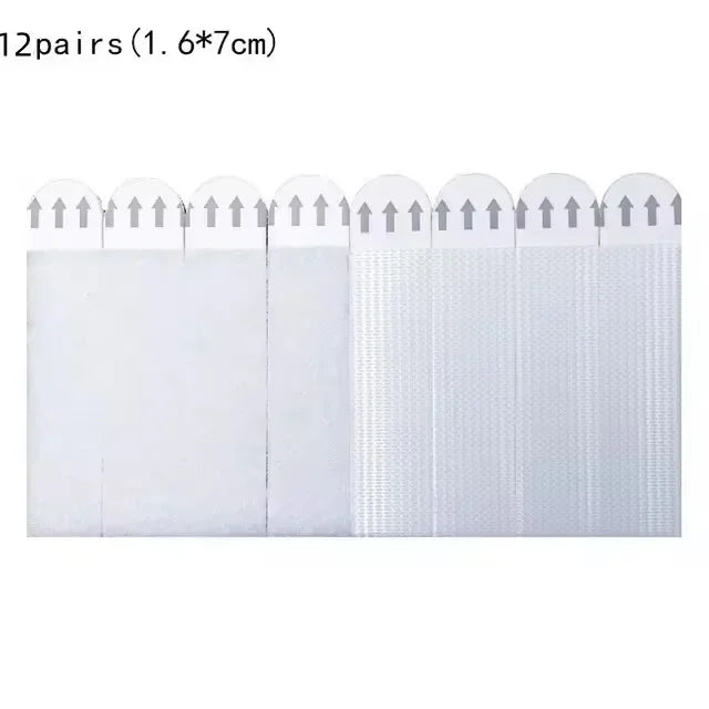 Twelve pairs of white picture hanging strips, measuring 1.6 by 7 cm, are shown in a row.