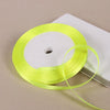 A spool of bright yellow satin ribbon is shown on a white background.