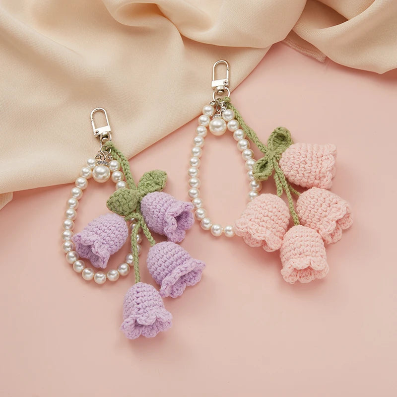 Handmade crocheted flower keyring charm in shades of purple and pink with pearl accents