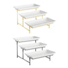 Elegant three-tier rectangular serving platter stand with gold and black metal frames.