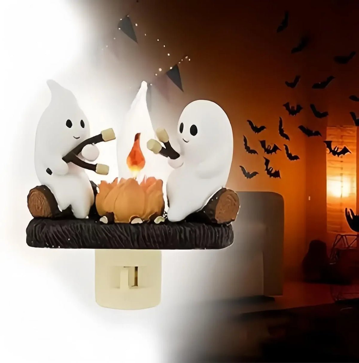 A white ghost figurine is shown next to a glowing orange bonfire in a night light display.