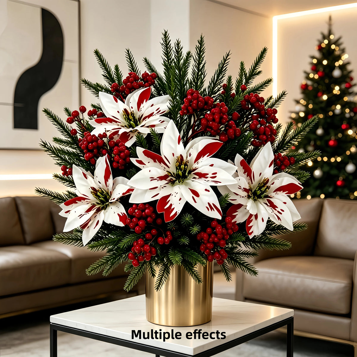 A bouquet of festive red and white artificial flowers featuring large lilies and greenery displayed on a gold vase.