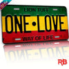 A rectangular metal wall sign featuring the text ONE LOVE in yellow and black on a green background.