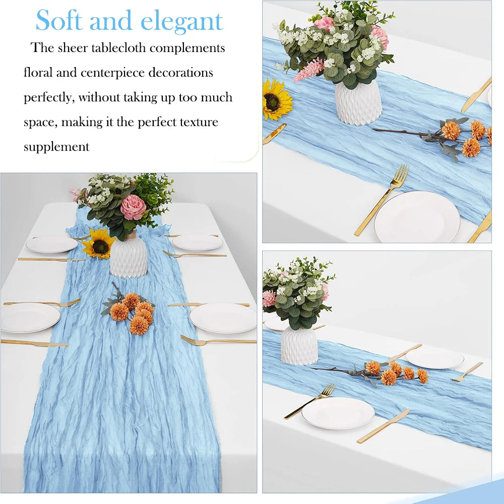 Light blue cheesecloth table runner with floral and centerpiece decorations on a white table.