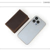 A dark brown vintage leather card holder and cable organizer next to a silver smartphone.