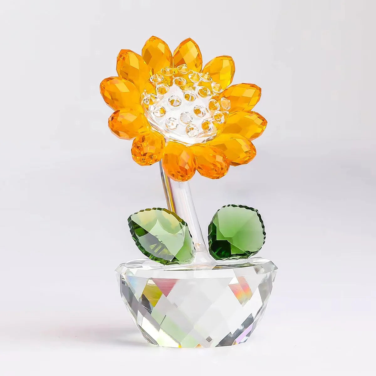 Handcrafted glass crystal sunflower figurine with a bud and green accents on a clear base