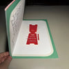 A close-up of a green and white letter sign ornament with red text that reads I love you