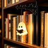 A vintage gothic bookshelf reading lamp with a black wrought iron arm and a glowing white ghost light hanging over old books.